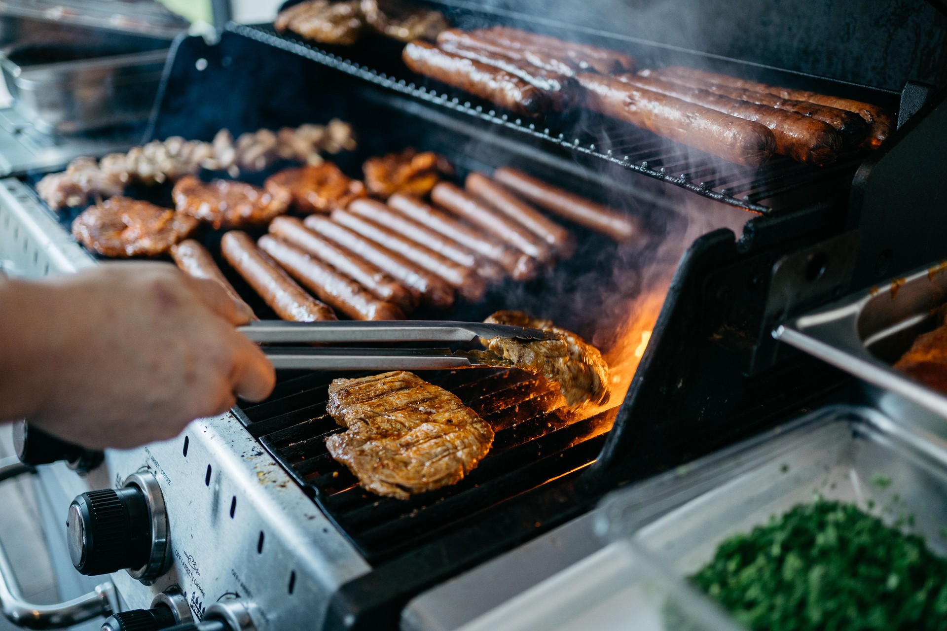 Grilling Meat and Hot Dogs on Gas Barbecue Grill